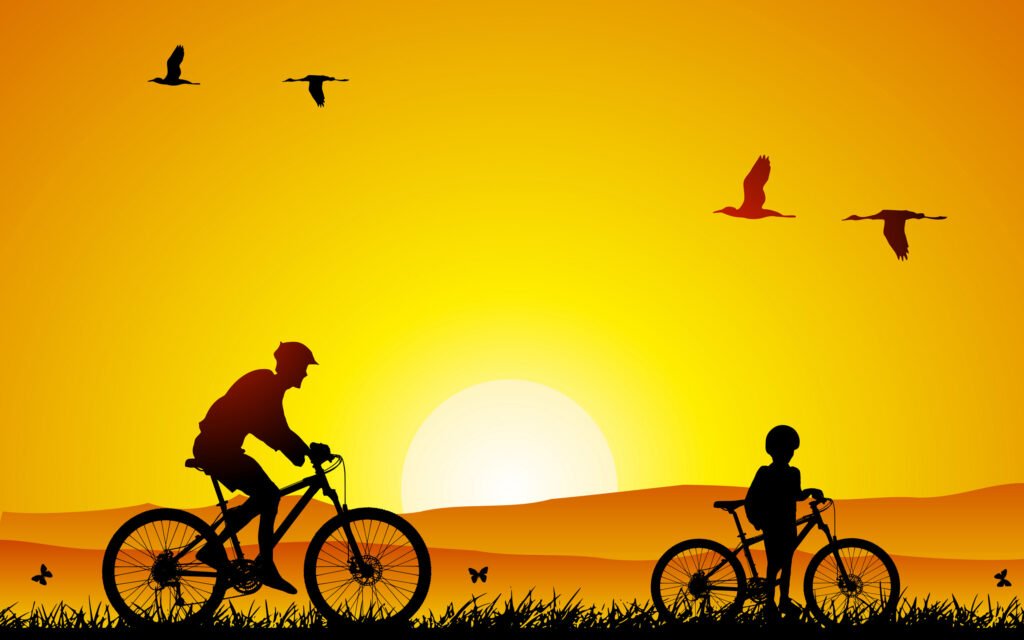 adulto e crainça andando de bicileta, com o por do sol ao fundo