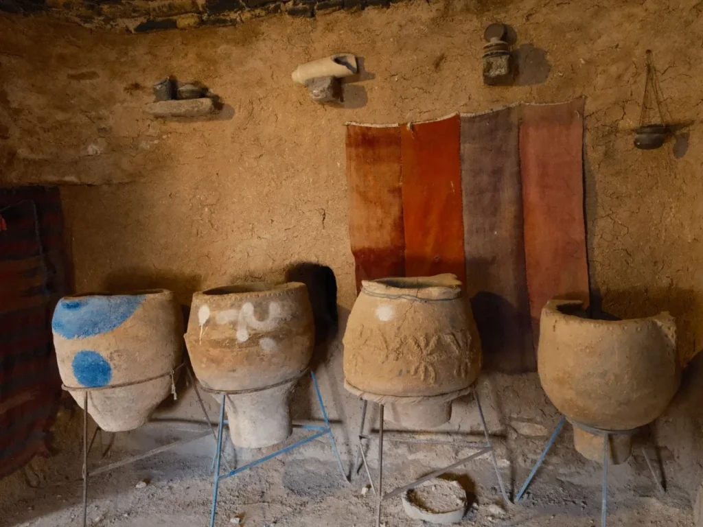 Vasos de cerâmica indígena expostos lado a lado sobre suportes