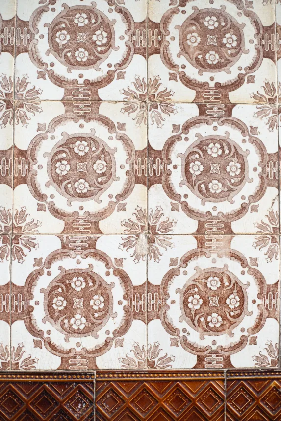 Azulejos com desenho ornamental em tons de marrom sobre fundo claro