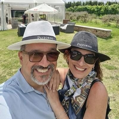 Casal de clientes com chapéus da Bodega Pizzorno